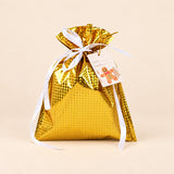 TibaToes Christmas Gift Bag, Small, Starlight Gold, ribbon closure on a warm beige studio background.