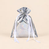 TibaToes Christmas Gift Bag, Small, Twinkle Silver, ribbon closure on a warm beige studio background.
