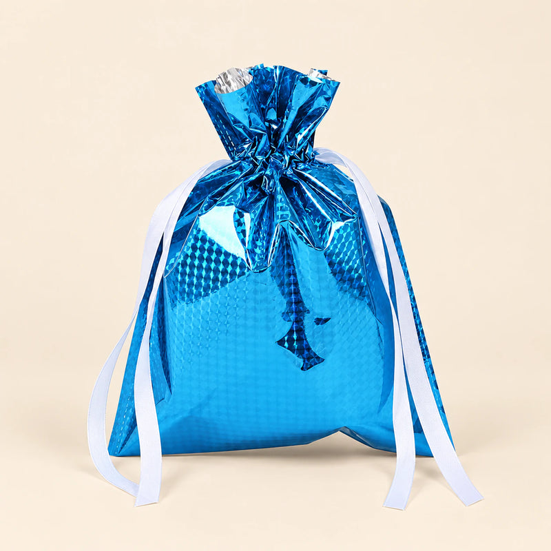 TibaToes Christmas Gift Bag, Small, Winter Sky Blue, ribbon closure on a warm beige studio background.