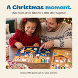 Original photograph of an adult and child arranging the Nativity sticker scene at a table.
