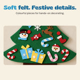 Close-up of the felt Christmas tree decorations, including candy canes, presents and a snowman face.