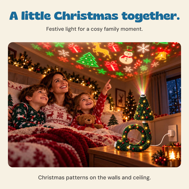 A mother and two children enjoy the Christmas tree projector in a cosy room, with the glowing tree and ring base on a bedside table.