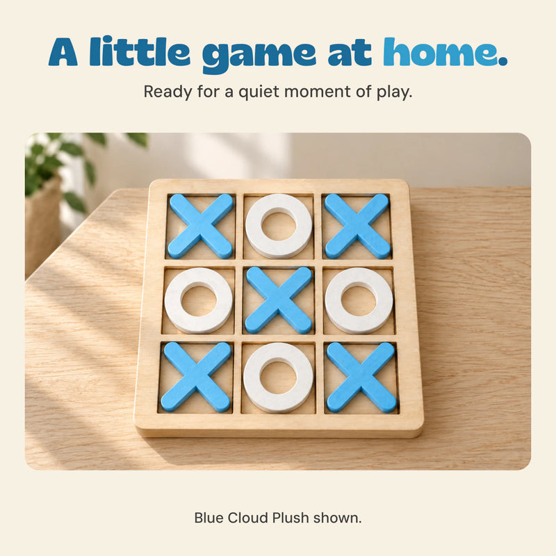 The blue and white wooden game board on a pale oak table in a calm home setting.