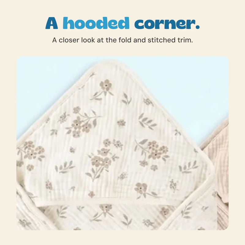 Close view of the floral towel hood, gathered fabric texture and stitched edge.