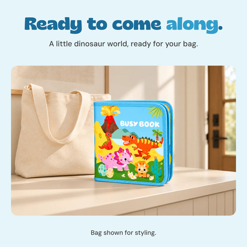 Closed dinosaur activity book standing beside a plain canvas bag in a quiet entryway.