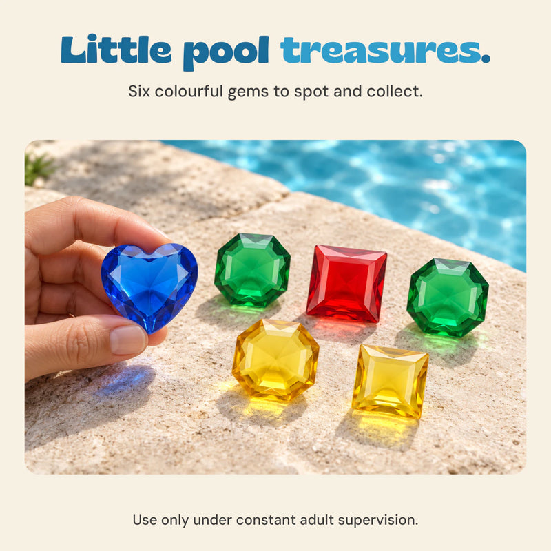 An adult hand holds the blue heart gem beside a pool, with the other five colourful gems on the coping. Six-gem set shown. Use only under constant adult supervision.