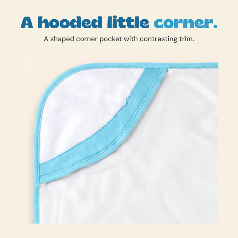 Close view of the white towel hood corner and sky blue stitched edge binding.