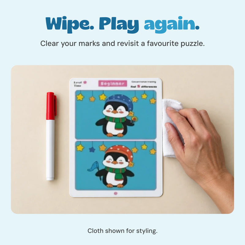Adult hand with a white cloth beside the unchanged reusable penguin puzzle and capped marker.