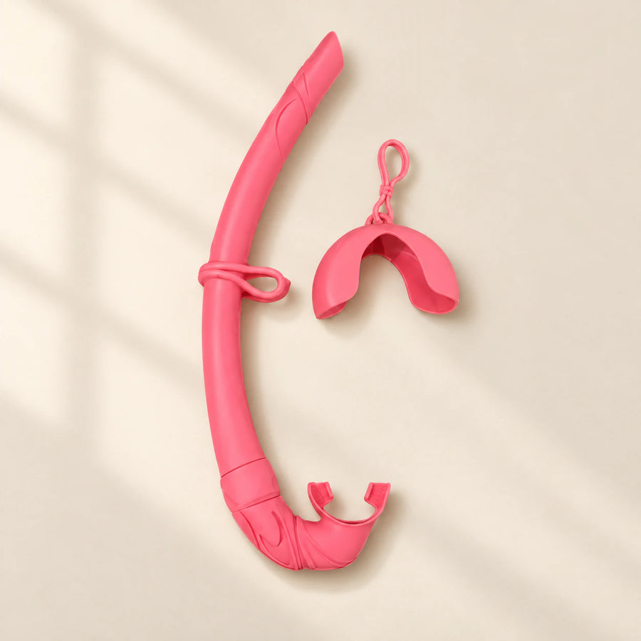 TibaToes foldable snorkel in Pink Cloud Plush, with its curved silicone tube, mouthpiece, mask keeper and matching storage cover.