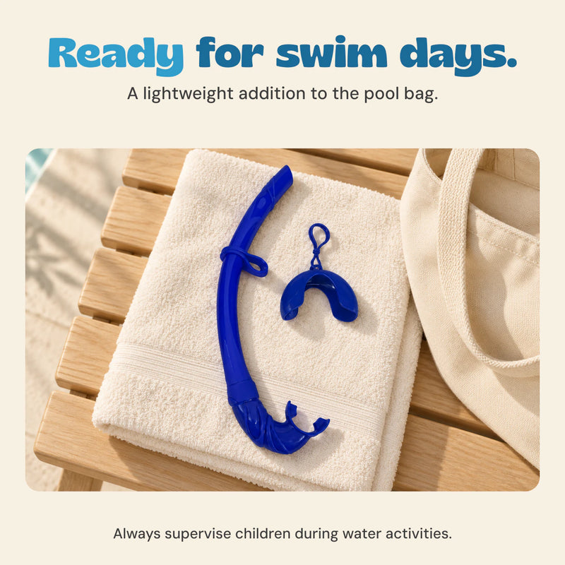 Blue foldable snorkel and matching cover resting on a towel beside a cream pool bag.