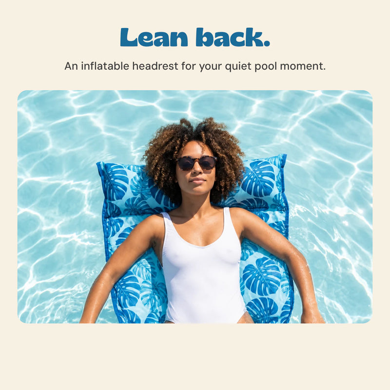 DriftLeaf Ocean Palm pool hammock headrest supporting an adult relaxing in the pool.
