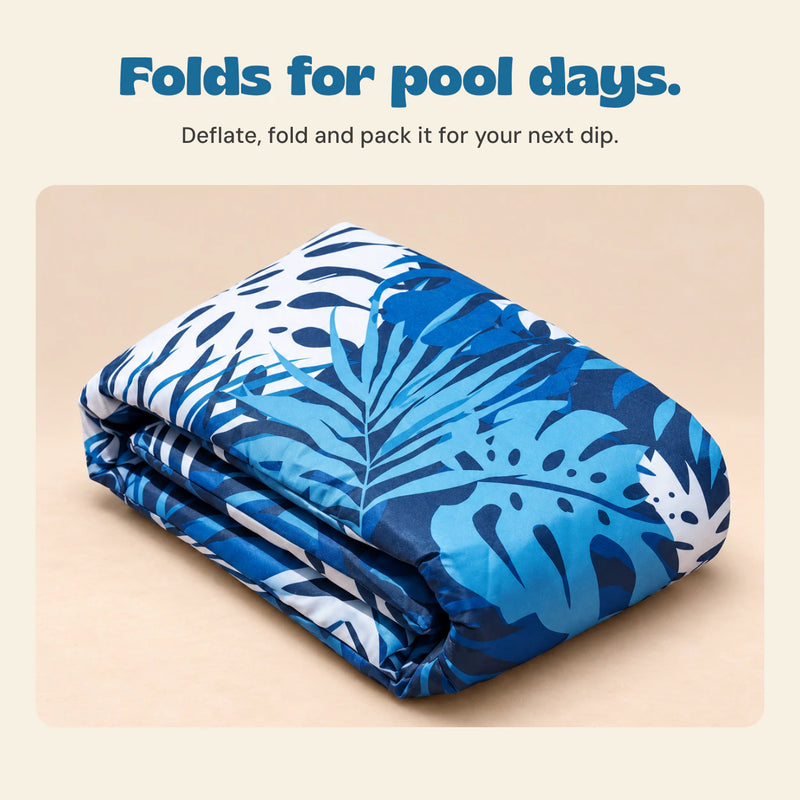 DriftLeaf Ocean Palm pool hammock deflated and folded on a warm beige studio background.