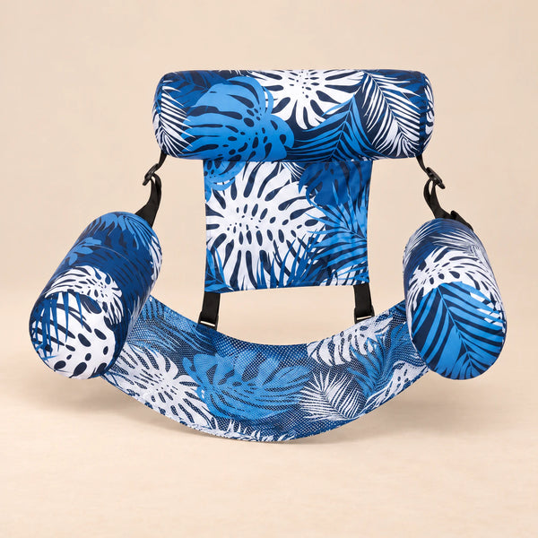 DriftLeaf Ocean Palm pool hammock in blue, navy and white tropical leaf print on a warm beige studio background.