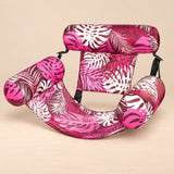 DriftLeaf Berry Palm pool hammock in pink, burgundy and white tropical leaf print on a warm beige studio background.