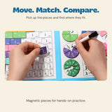 Hands holding a magnetic fraction piece and a marker over the original FractionMaster board.