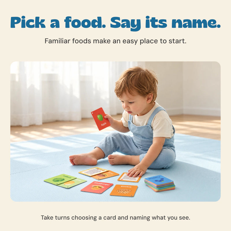 The child from the original product photo looks at an Apple flashcard while sitting beside the food cards.