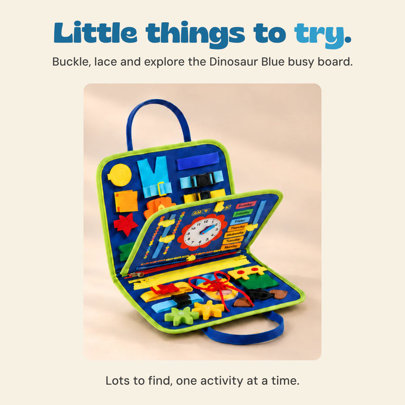 The exact blue dinosaur busy board open to show the buckle, zip, lacing, clock and detachable felt activities.