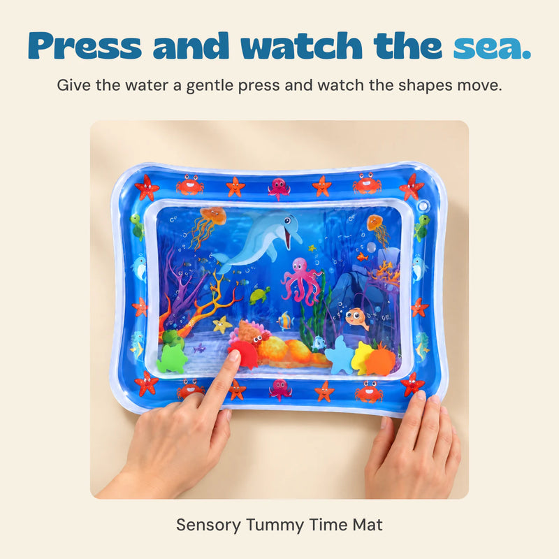 Hands press the blue-bordered ocean water mat to move its floating shapes.