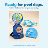 The blue bundle’s dinosaur beach ball, blue goggles, space-bear backpack and narwhal swim cap sit together beside a swimming pool.