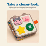 Close-up of the BusyBuddy felt hippo, pig and shape-matching page.