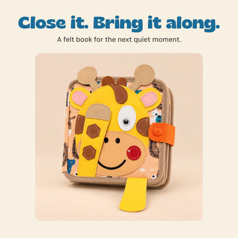 Closed giraffe-face BusyBuddy felt activity book with its orange tab.