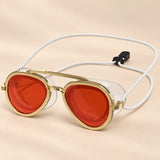 SplashView swim goggles in Coral Red with gold-coloured rims, clear seals and white adjustable cord.