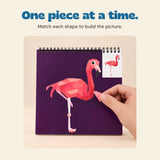 A hand placing a matching polygon sticker onto a flamingo picture.