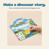 A hand placing a dinosaur sticker onto the dinosaur scene.