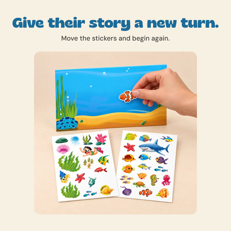 A hand placing a clownfish sticker on the ocean scene.