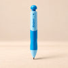 EasyHold Guided Writing Pencil. Clean product photograph on a warm beige studio surface.