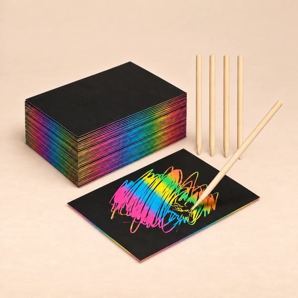 RainbowReveal black scratch art sheets with wooden scratch sticks on a beige background.