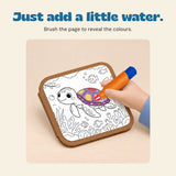 A hand revealing a colourful turtle using the orange water pen.