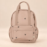 Little Explorer Large Backpack. Tiny Paw Blush. Clean product photograph on a warm beige studio surface.