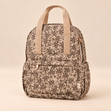 Little Explorer Large Backpack. Vintage Garden Beige. Clean product photograph on a warm beige studio surface.