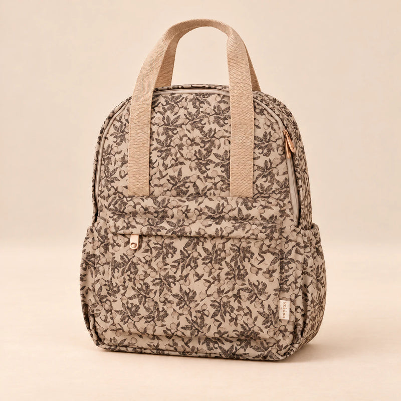 Little Explorer Large Backpack. Vintage Garden Beige. Clean product photograph on a warm beige studio surface.