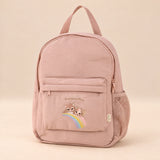 Little Explorer Large Backpack. Rainbow Blush. Clean product photograph on a warm beige studio surface.