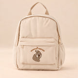 Little Explorer Large Backpack. Gentle Bear Cream. Clean product photograph on a warm beige studio surface.