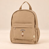 Little Explorer Large Backpack. Teddy Cocoa Tan. Clean product photograph on a warm beige studio surface.
