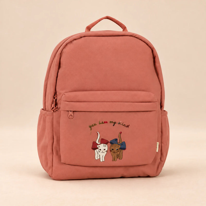 Little Explorer Large Backpack. Bestie Brick Rose. Clean product photograph on a warm beige studio surface.