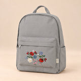 Little Explorer Large Backpack. Bloomy Cloud Grey. Clean product photograph on a warm beige studio surface.
