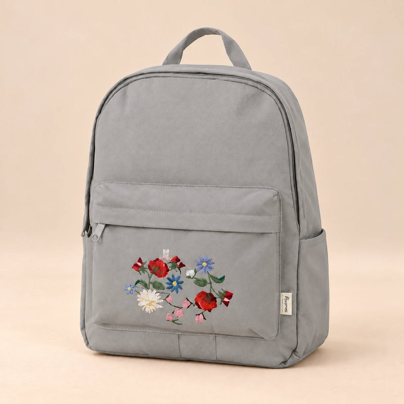 Little Explorer Large Backpack. Bloomy Cloud Grey. Clean product photograph on a warm beige studio surface.
