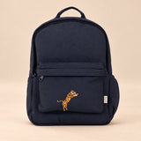 Little Explorer Large Backpack. Safari Navy. Clean product photograph on a warm beige studio surface.