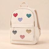Little Explorer Large Backpack. Sweetheart Cream. Clean product photograph on a warm beige studio surface.