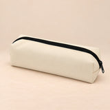 Everyday Pencil Pouch. Soft Grey. Clean product photograph on a warm beige studio surface.