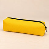 Everyday Pencil Pouch. Sunny Yellow. Clean product photograph on a warm beige studio surface.
