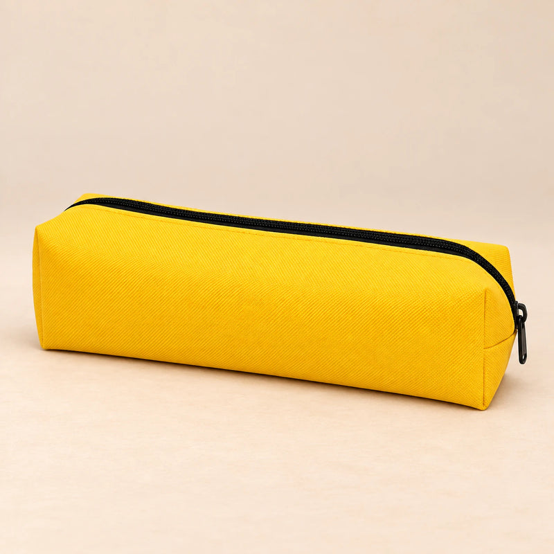 Everyday Pencil Pouch. Sunny Yellow. Clean product photograph on a warm beige studio surface.