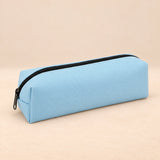 Everyday Pencil Pouch. Powder Blue. Clean product photograph on a warm beige studio surface.