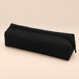 Everyday Pencil Pouch. Classic Black. Clean product photograph on a warm beige studio surface.