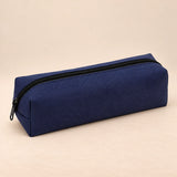 Everyday Pencil Pouch. Navy Blue. Clean product photograph on a warm beige studio surface.