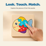 An adult hand touches the turquoise piece of the assembled Fish wooden puzzle on a warm beige surfacetop.